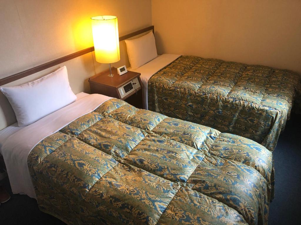 Postel nebo postele na pokoji v ubytování Hotel 28 Hiroshima