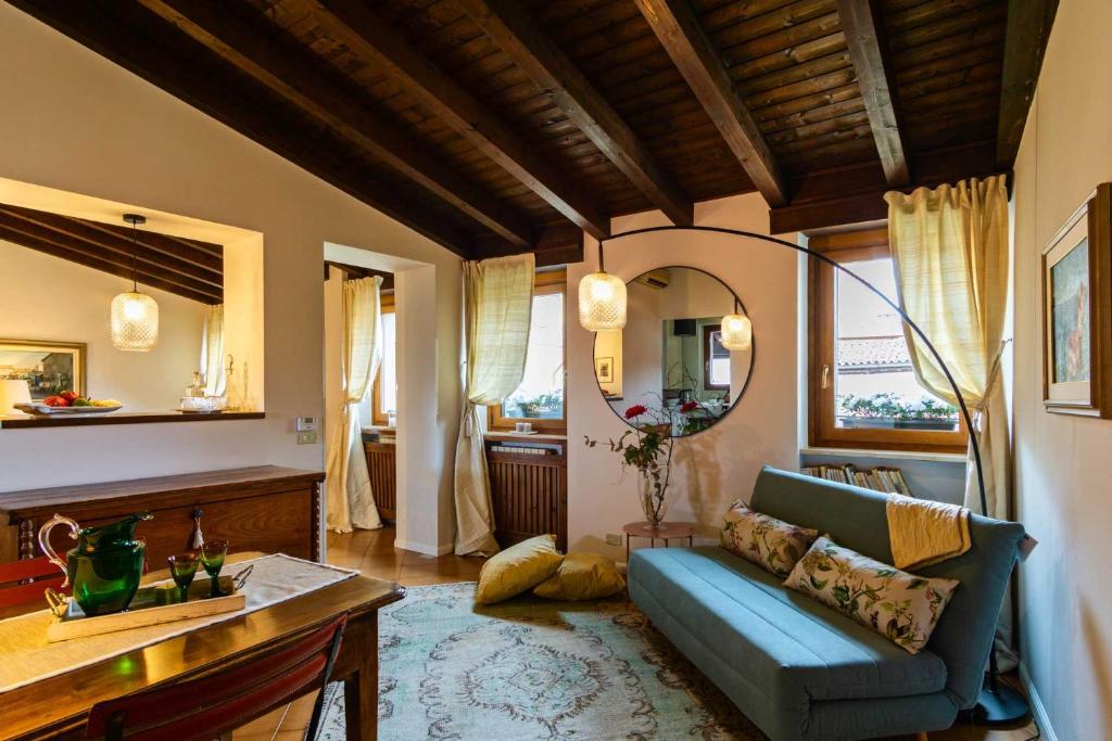 a living room with a blue couch and a mirror at Residenza...Cara Giulietta... in Verona