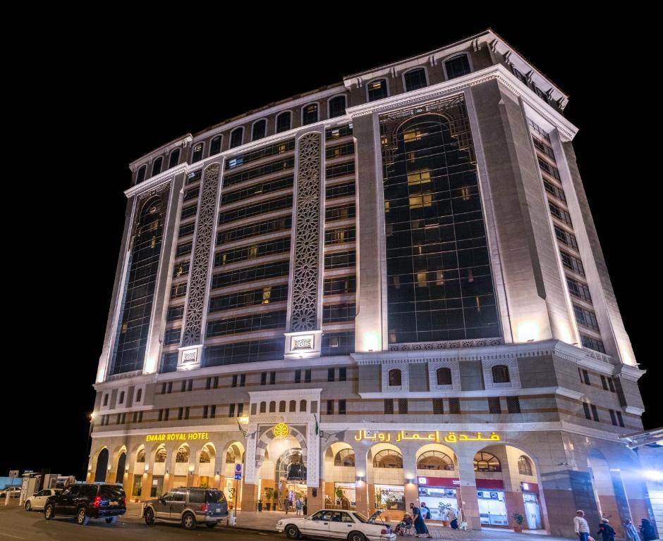 فندق إعمار رويال في المدينة المنورة: مبنى كبير فيه سيارات تقف امامه