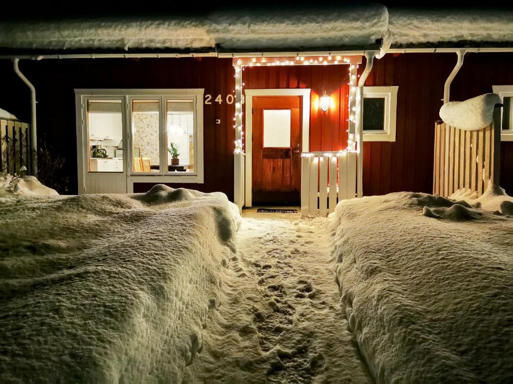 a room with snow covered walls and a door with lights at Jojos Lodge in Bräcke