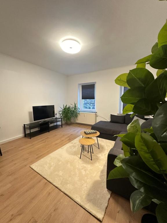 a living room with a couch and a table at Ferienwohnung Haus Paraschiv in Aue