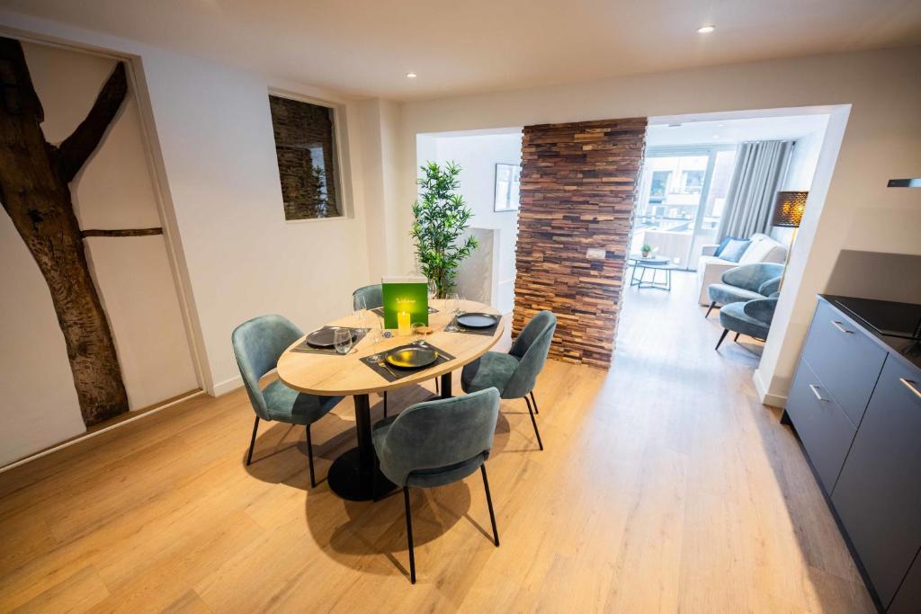 a kitchen and dining room with a table and chairs at Historical 80m2 Retreat with Sauna option in Eindhoven