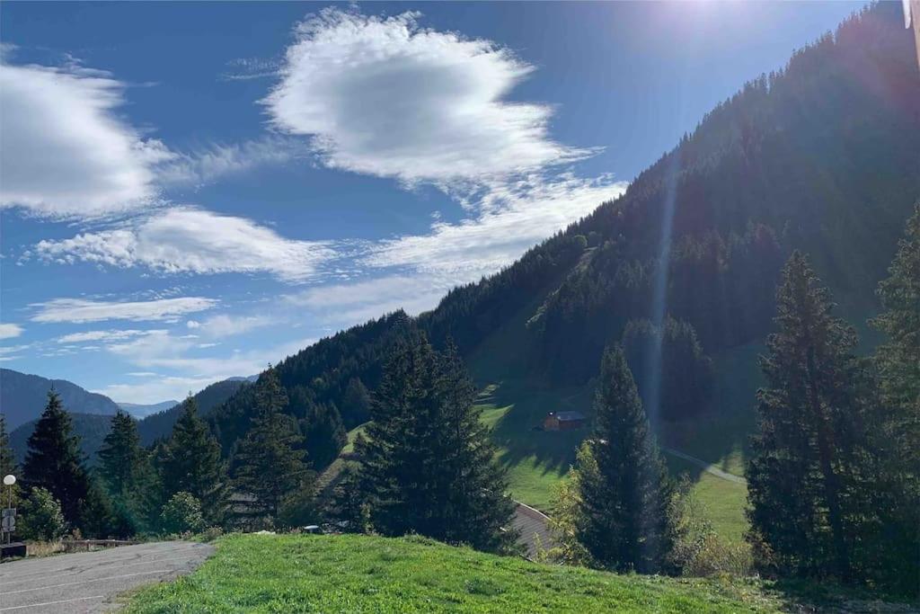 - une vue sur une montagne arborée et une route dans l'établissement Appartement à la montagne (jusqu'à 6 personnes), à Le Biot