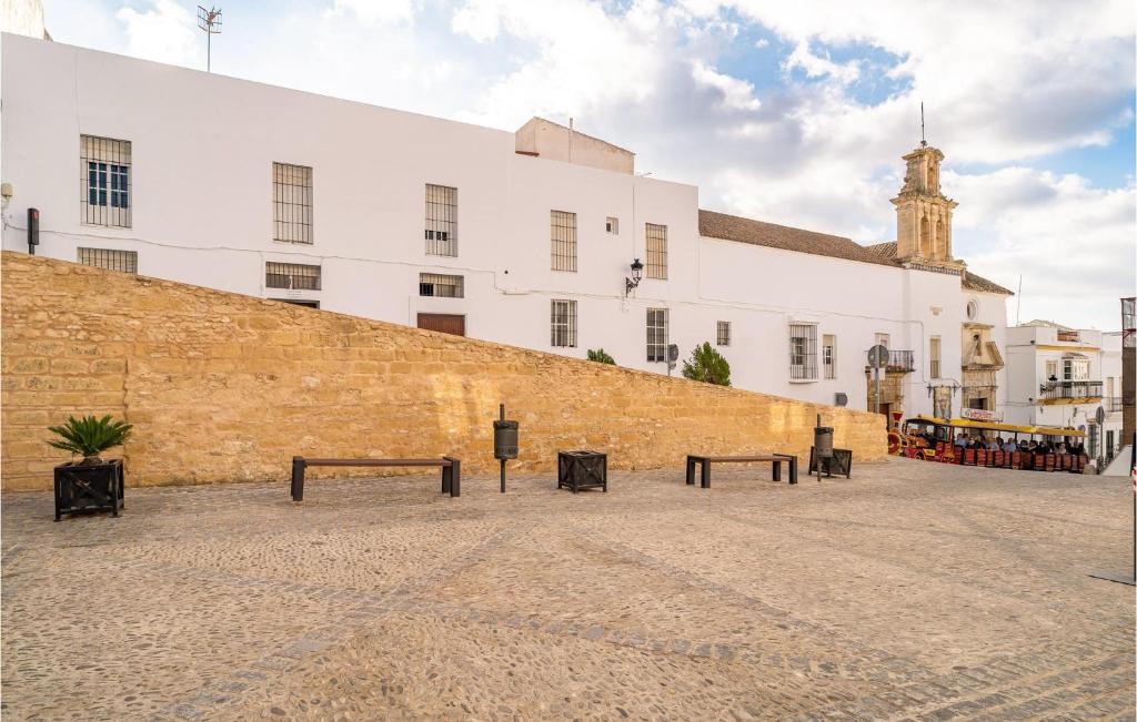a group of benches in front of a building at Nice Apartment In Arcos De La Frontera in Arcos de la Frontera