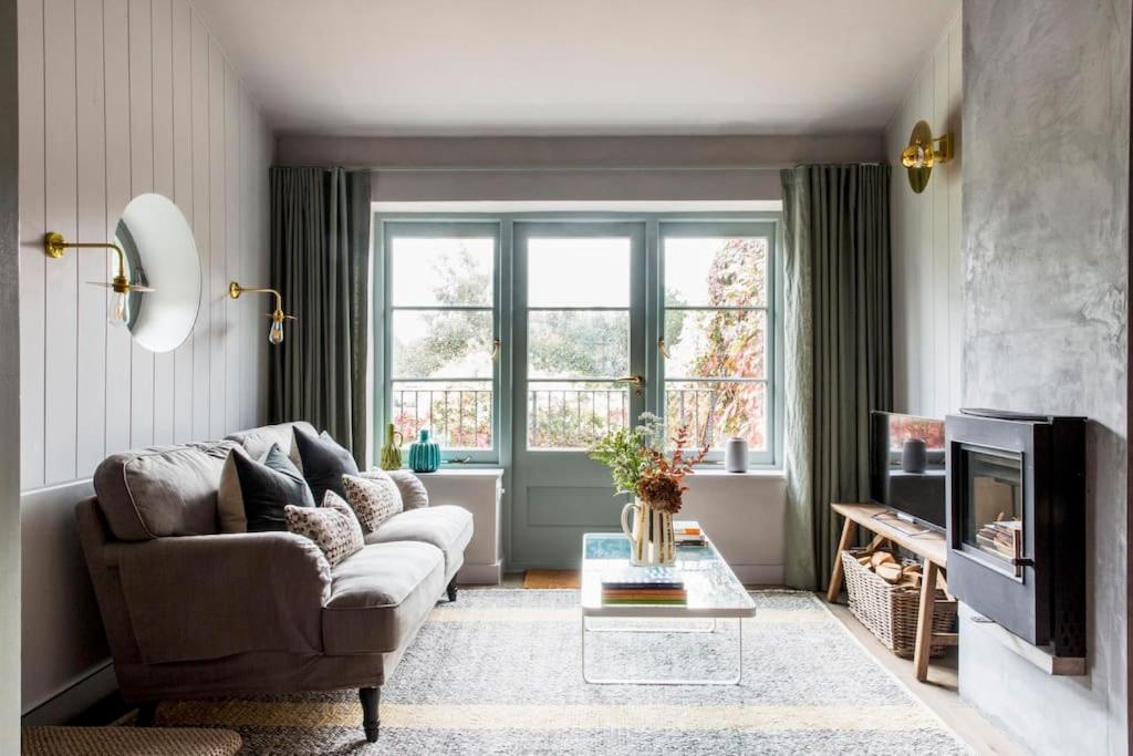 a living room with a couch and a television at The Loft House in Hinton Charterhouse