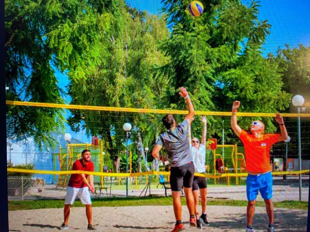 a group of men playing a game of volley ball at MOBIL HOME Clim BOOFZHEIM 6 PERSONNES 3 CHAMBRES LE RIED 3 ETOILES PROCHE EUROPA PARK in Boofzheim