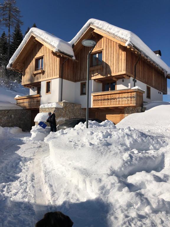 a house covered in snow in front at Golfchalet 3 confini in Tarvisio