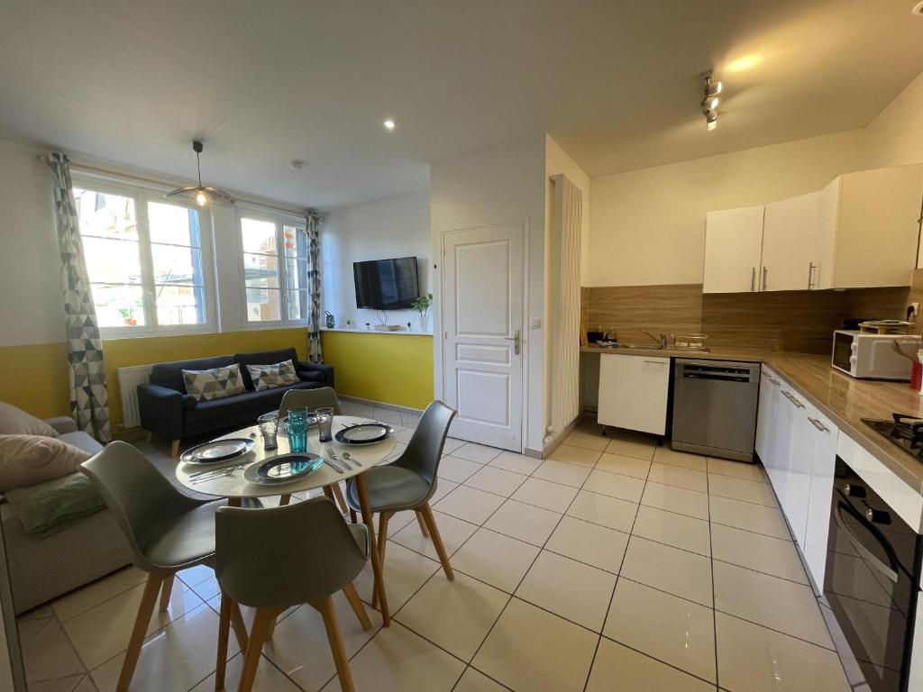 a kitchen and living room with a table and chairs at The Central's Pearl - Centre - 6p - Rêve au Mans in Le Mans