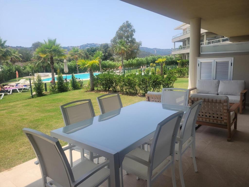 a blue table and chairs on a patio at Luxury La Cala Golf Haven with terrace & pool in La Cala de Mijas