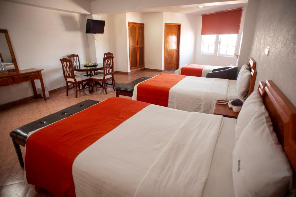 Postel nebo postele na pokoji v ubytování Hotel Atenas