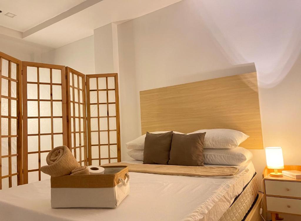 a bedroom with a bed with a box on it at Japandi-inspired Hideaway in Dumaguete