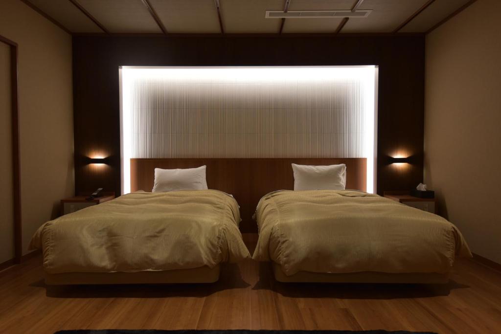 Postel nebo postele na pokoji v ubytování Arima Onsen Taketoritei Maruyama