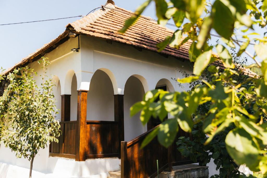 uma pequena casa branca com um telhado castanho em Sentina kuća em Vrtovac