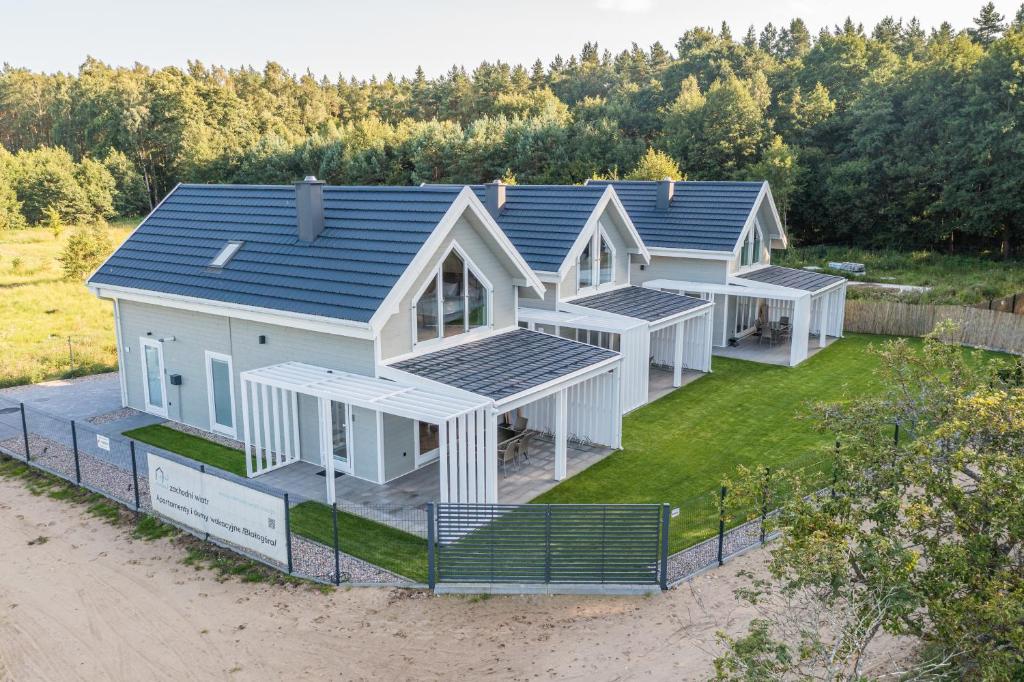 an aerial view of a house with solar panels on it at Zachodni Wiatr - dom Pinus in Białogóra