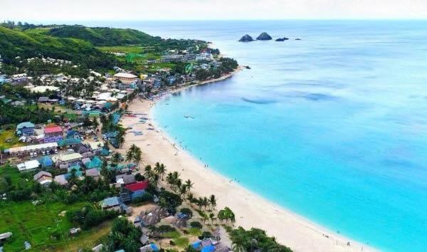 an aerial view of a beach with houses and the ocean at Bia's Beach House, Pagudpud in Pagudpud