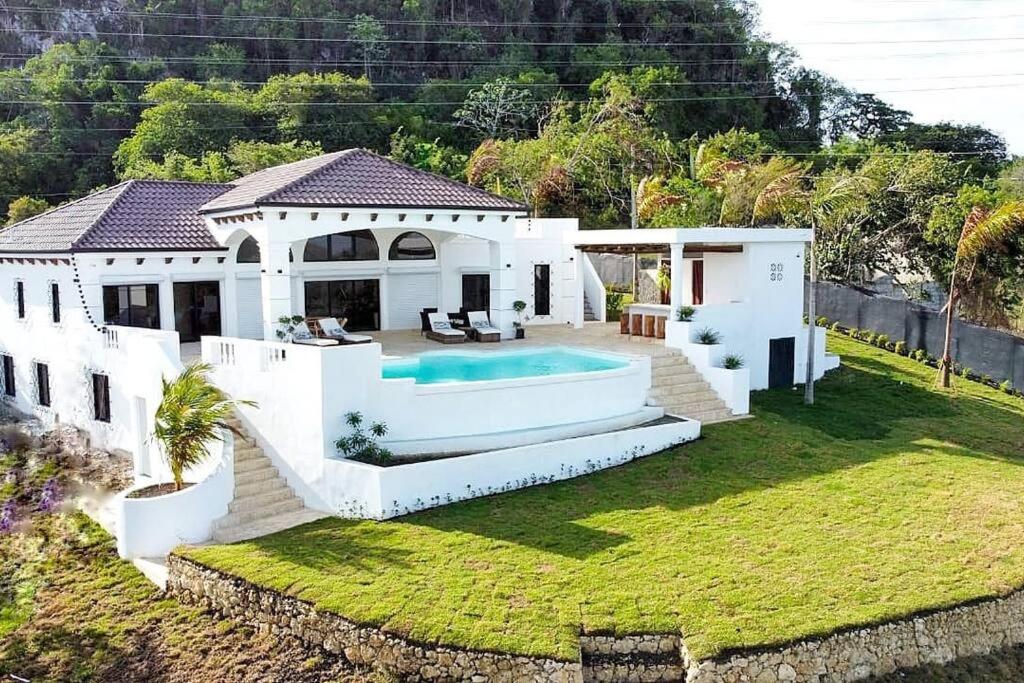 a house with a swimming pool in the yard at Beautiful villa with pool in San Felipe de Puerto Plata