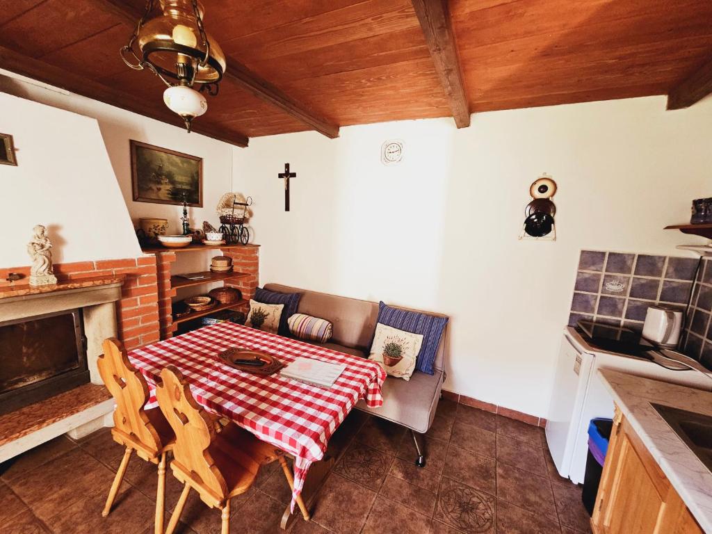 a living room with a table and a cross on the wall at Stateček plný zvířátek 