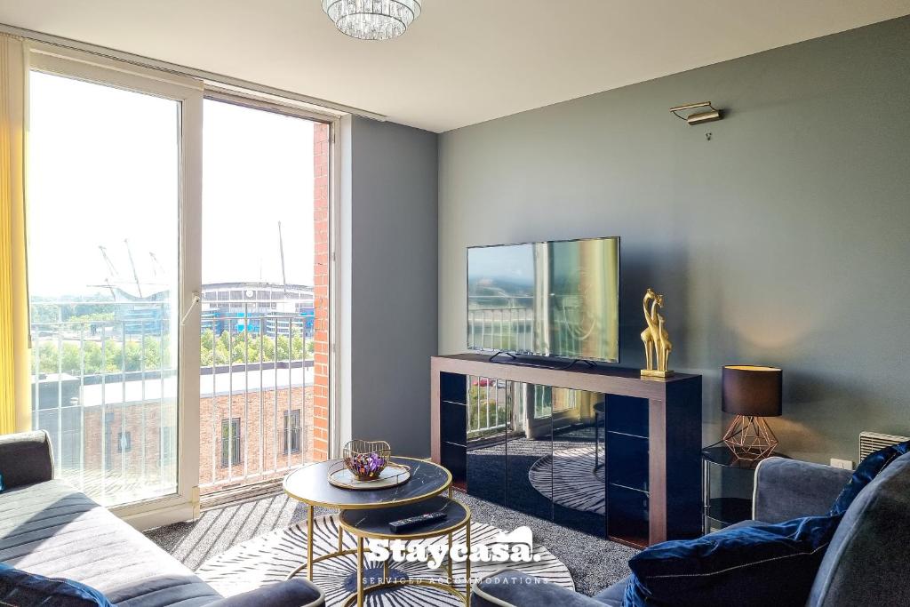 a living room with a couch and a tv at Luxury 1 Bed Apartment Beautiful View With Parking in Manchester