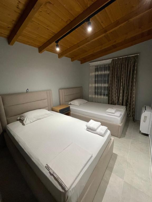 a bedroom with two beds and a window at Luxury Rooftop Vlora in Vlorë