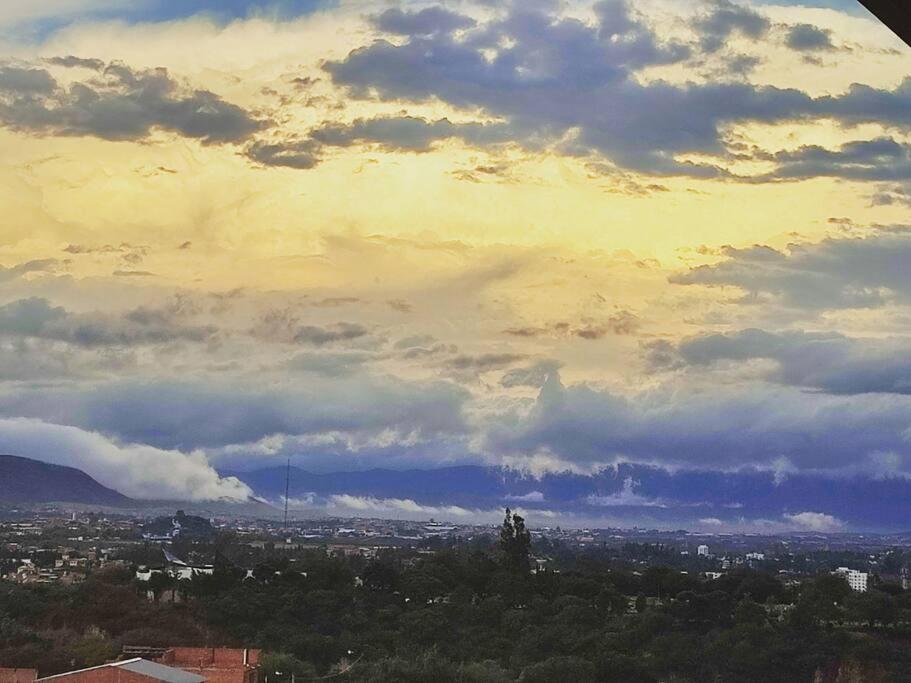 a view of a city under a cloudy sky at Departamento con excelente vista de la ciudad in Tarija