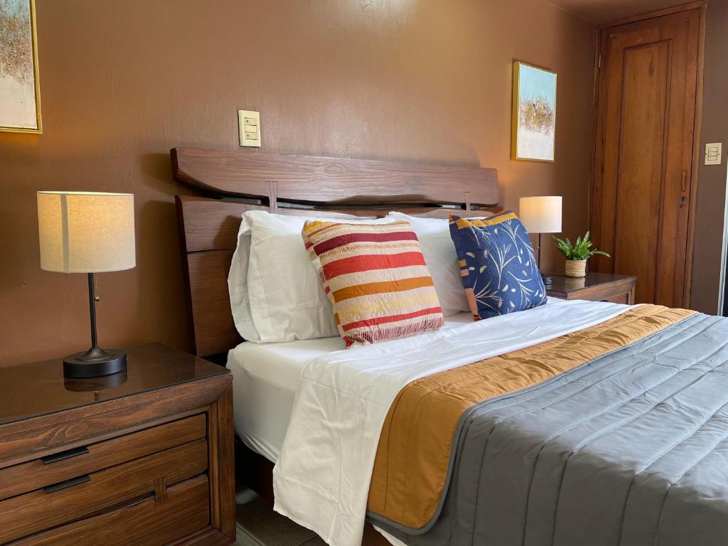 a bedroom with a large bed with two pillows at The Rainier Bed & Breakfast 1 in San José