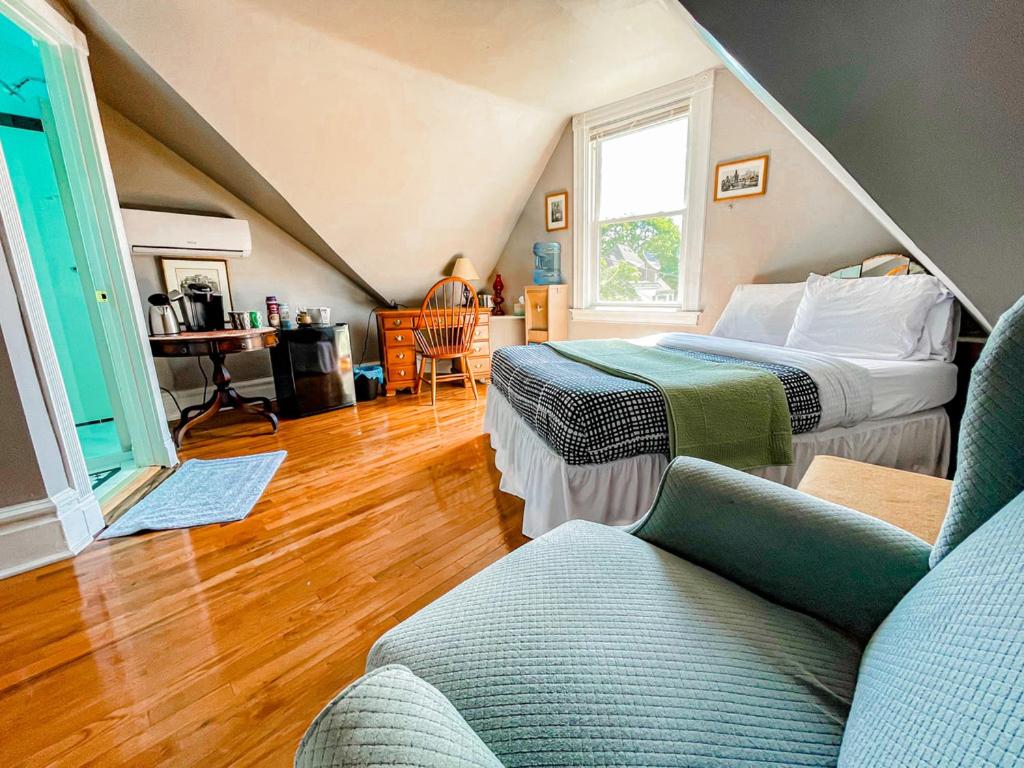 a room with two beds and a couch in it at Point Breeze Guest House in Pittsburgh