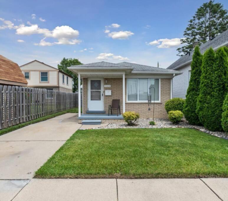 a house with a fence and a yard at Modern River Retreat near airport, hospitals, businesses 