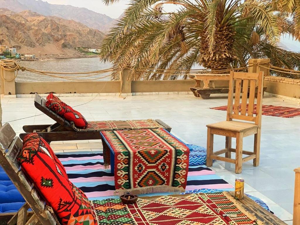 a room with a table and a chair and a table and a tableablish at Calma Mocha House in Dahab