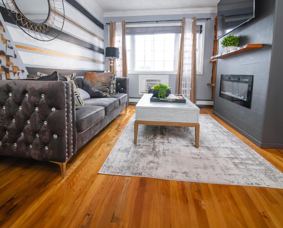 a living room with a leather couch and a coffee table at Brooklyn Double Decker in Brooklyn