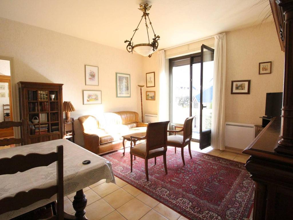 a living room with a couch and a table at Appartement Bagnères-de-Luchon, 3 pièces, 4 personnes - FR-1-313-228 in Luchon