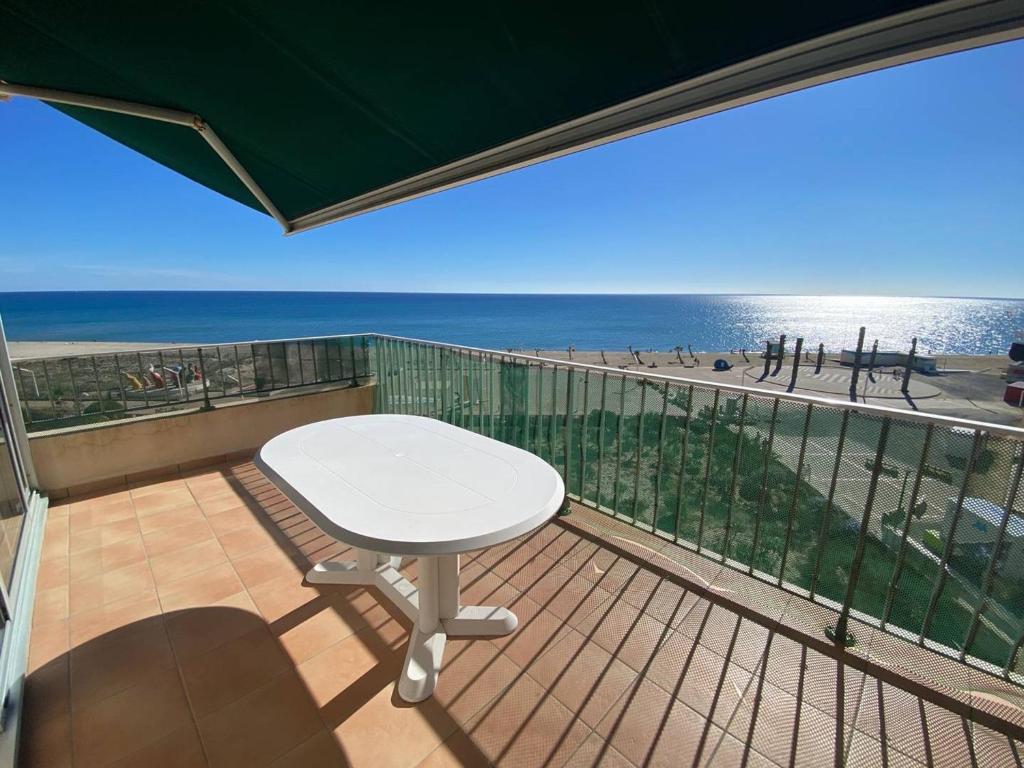 d'un balcon avec une table et une vue sur la plage. dans l'établissement Duplex T3 avec Clim, Parking et Wifi - 6 Pers, Le Barcarès - FR-1-81-606, au Barcarès