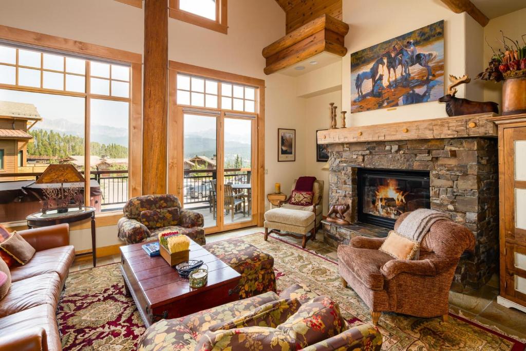 a living room filled with furniture and a fireplace at Penthouse 4 by Moonlight Basin Lodging in Big Sky