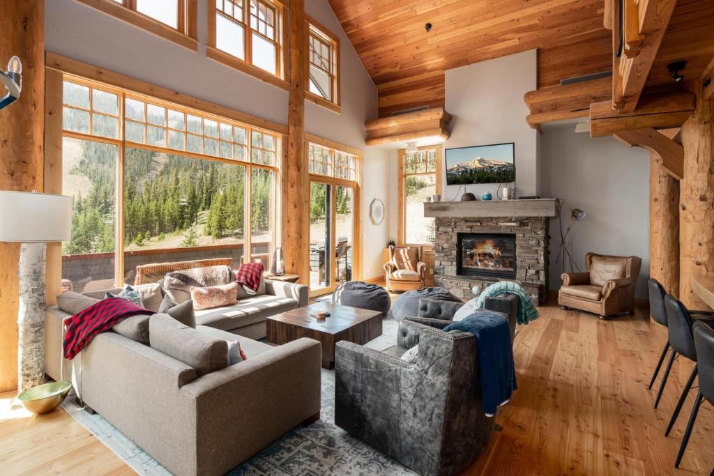a living room with couches and a fireplace at Penthouse 1 by Moonlight Basin Lodging in Big Sky