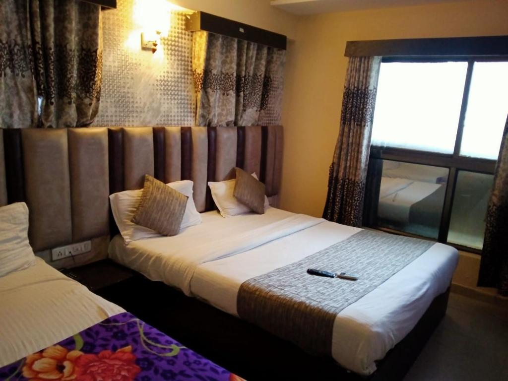 Postel nebo postele na pokoji v ubytování HOTEL DREAM INN