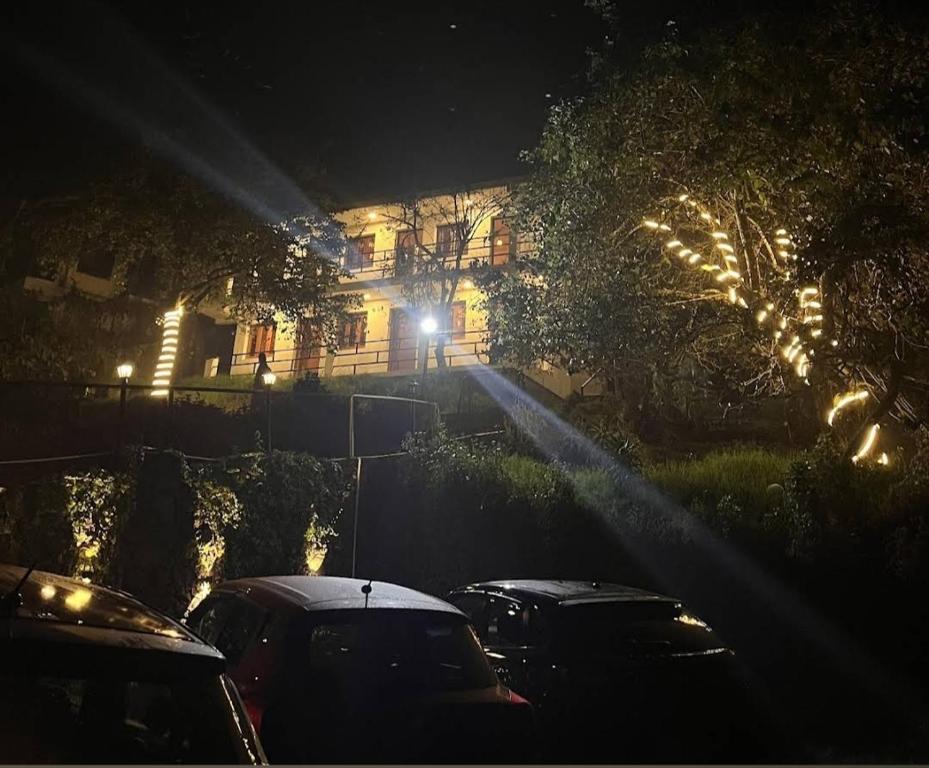 a group of cars parked in front of a house at night at Cloudsmisty kodai in Kodaikānāl