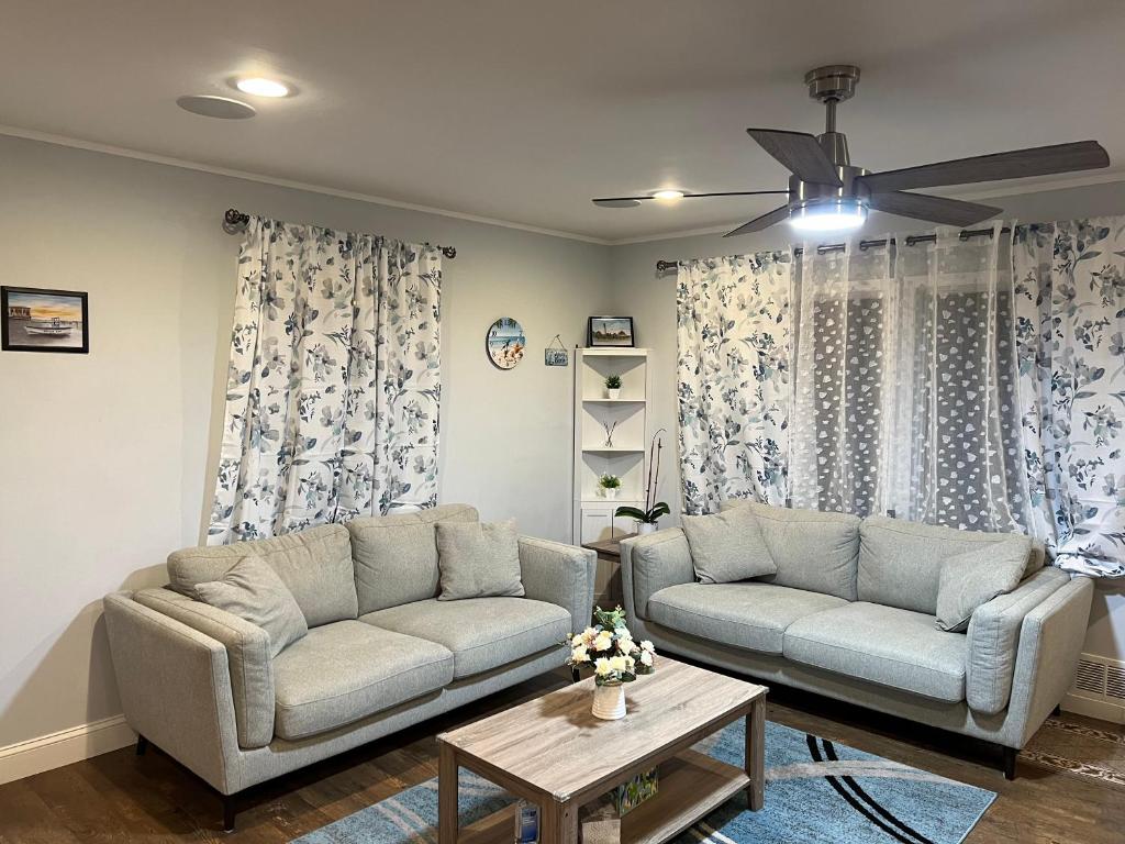 a living room with a couch and a table at Cozy, Spacious, Modern entire Vacation Home near beaches & boardwalks, pets & children friendly in Somers Point