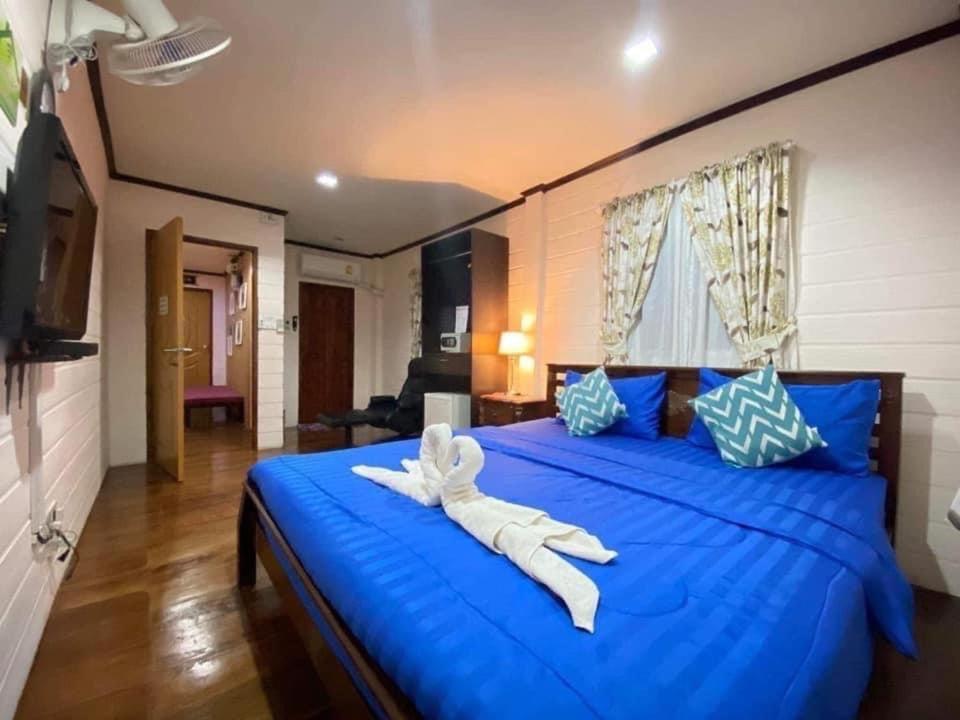 a large blue bed with a white animal on it at Granny One Guest House in Chiang Khan