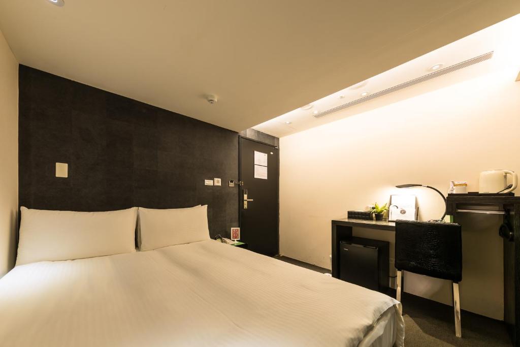 Postel nebo postele na pokoji v ubytování 凡登台北商務旅店