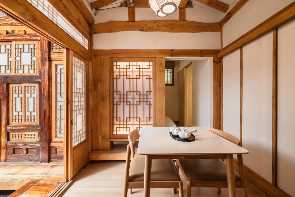 a dining room with a table and chairs at Luxury hanok with private bathtub - SN08 in Seoul