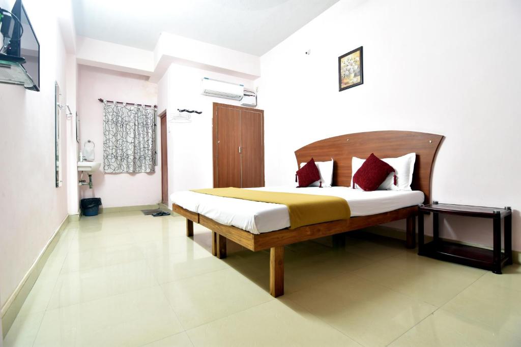 Postel nebo postele na pokoji v ubytování Royal Green Accommodation Chennai Airport