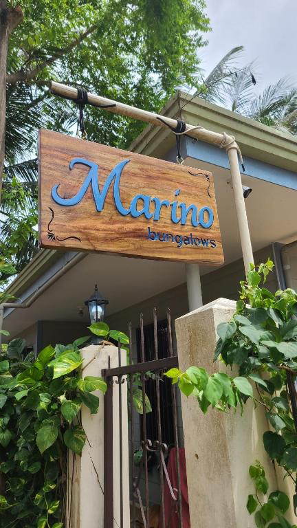 un panneau pour un barbier de marinoco sur un bâtiment dans l'établissement Marino Bungalows, à Île Bantayan