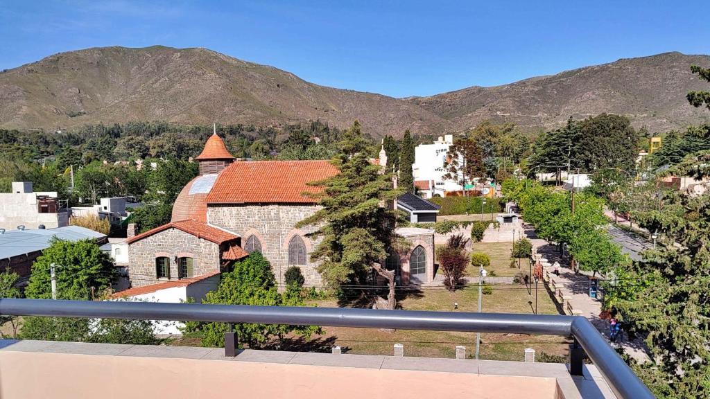 a view of a small town with a church at Edén Apartamento in La Falda