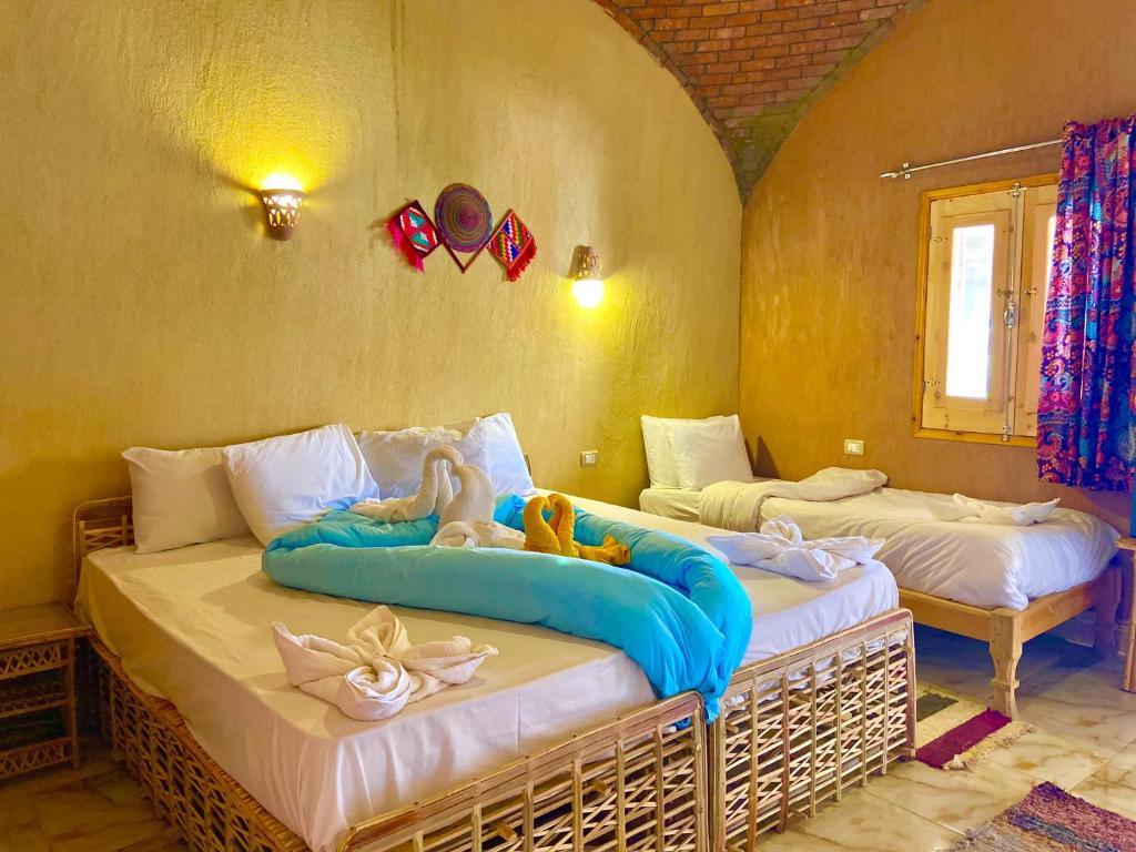 Postel nebo postele na pokoji v ubytování Kabara Nubian House