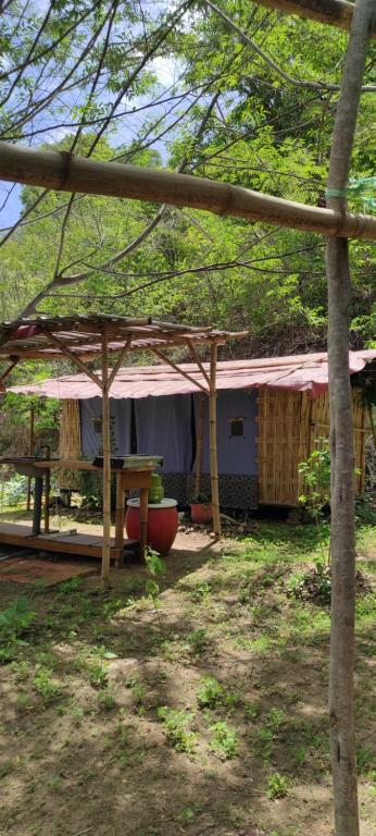 a house with a tent and a picnic table at Rent a Tent in Maluk