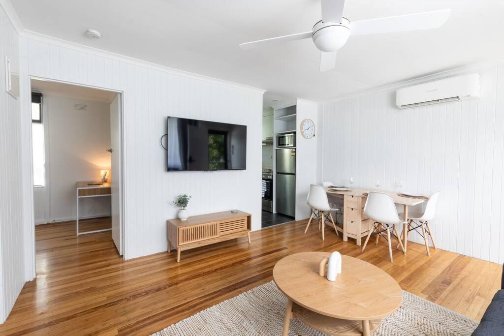 Una sala de estar con una mesa y un comedor. en Orton Waves- Beach Life Awaits, en Ocean Grove