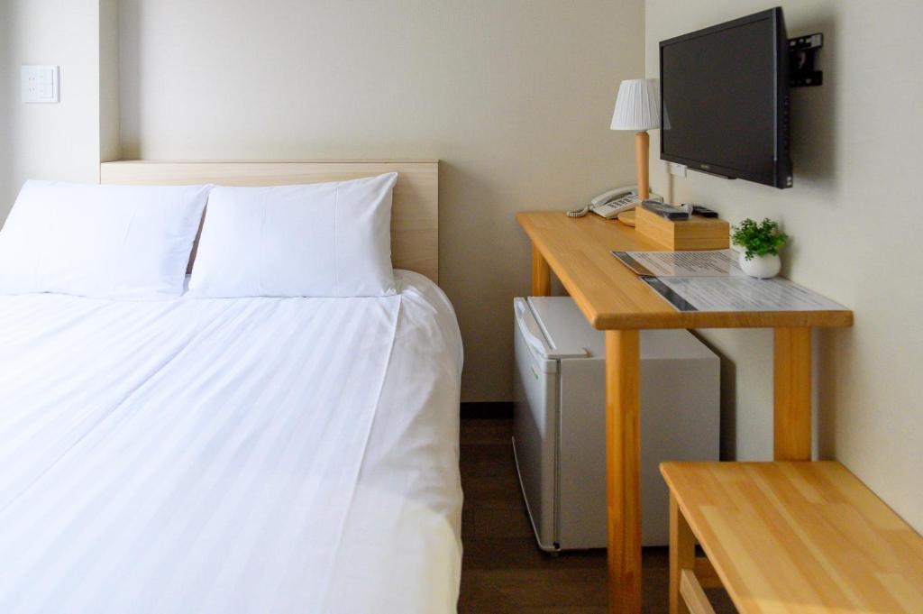 Postel nebo postele na pokoji v ubytování Ueno Woo Hotel
