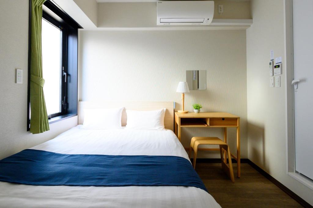 Postel nebo postele na pokoji v ubytování Ueno Woo Hotel