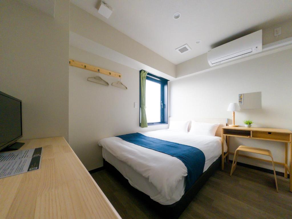 Postel nebo postele na pokoji v ubytování Ueno Woo Hotel