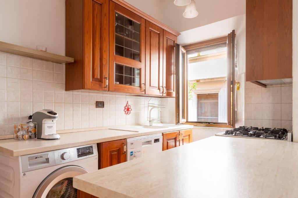 罗马Elegant & Quiet Apartment next to Colosseo的厨房配有木制橱柜和台面