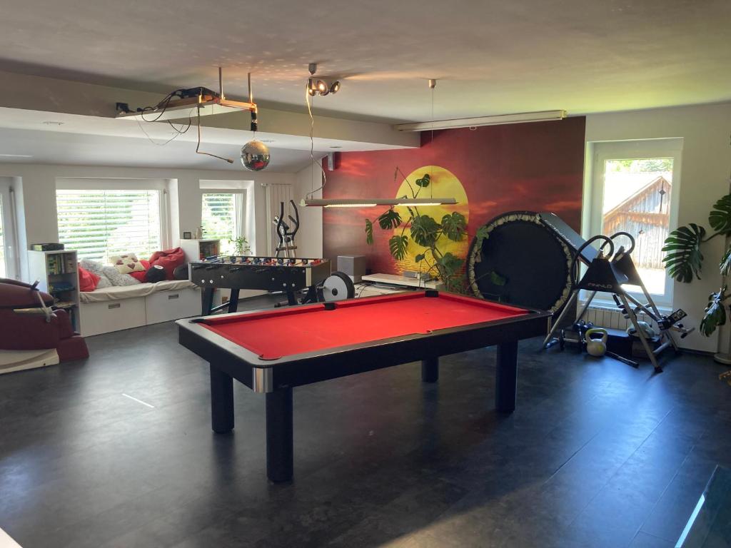 a living room with a ping pong table in it at Laura's house in Slovenj Gradec